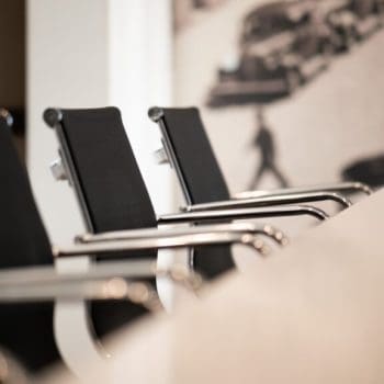 Empty chairs sitting beside a meeting table