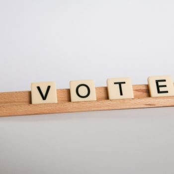 Scrabble tiles with letters spelling "Vote"