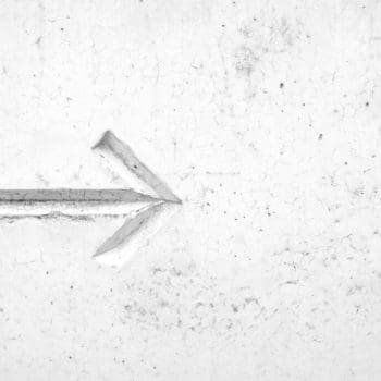 An arrow pointing right against a white marble background