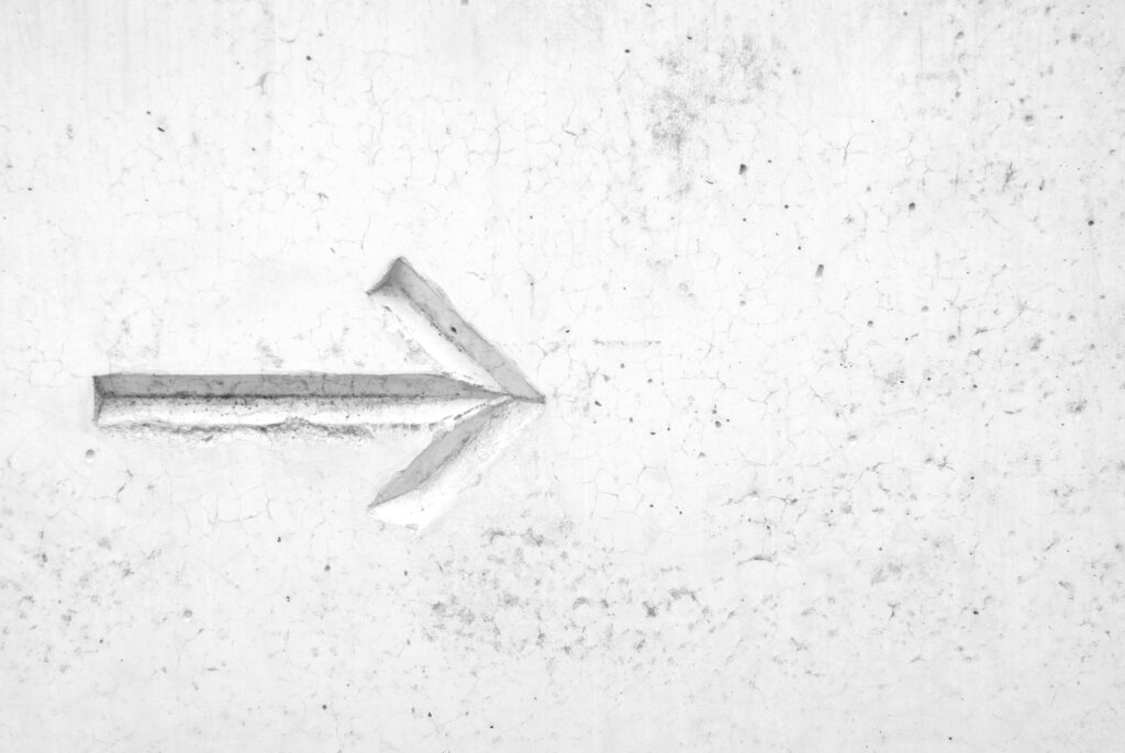 An arrow pointing right against a white marble background