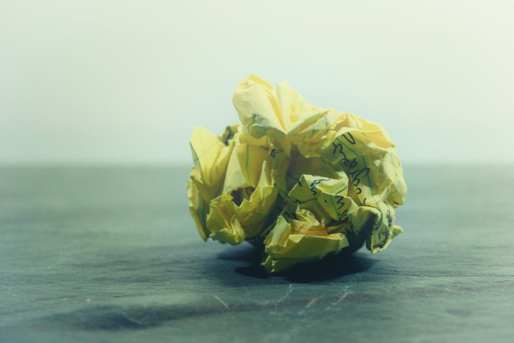 A crumpled up piece of yellow paper