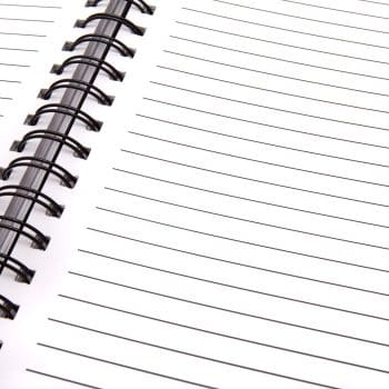 Close-up of blank pages in a spiral notebook