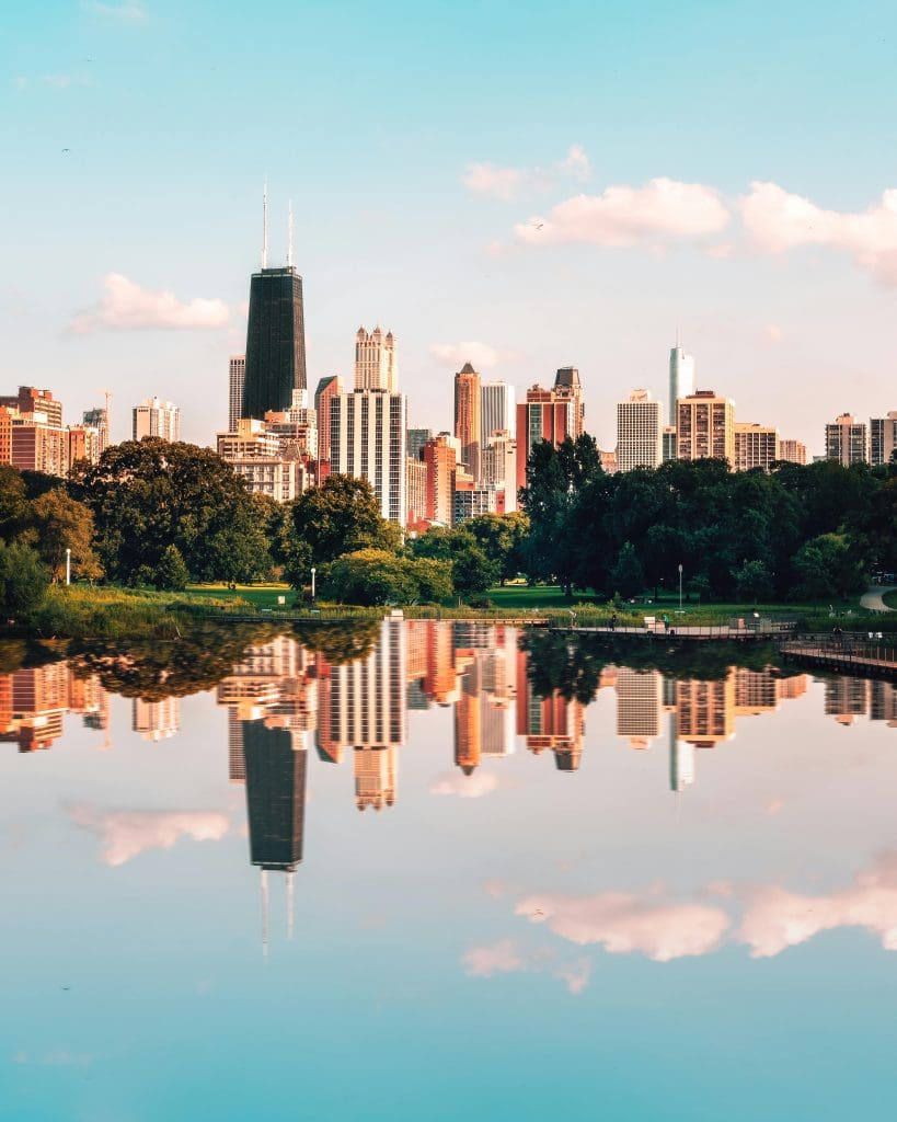 The Chicago skyline reflected against the surface of a nearby body of water